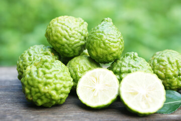 Bergamot fruits and leaves on  wooden background. Concept, herbal fruits with sour taste, can be cooked as food seasoning and use for spa , aroma. Medicinal herb.                      