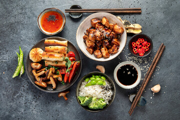 Homemade sesame Chicken served with white rice and vegetables. Asian food dishes.
