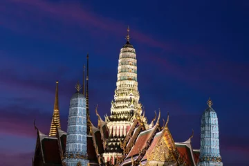 Deurstickers Grand Palace (Wat Phra Kaew) at night in Bangkok, Thailand. Buildings illuminated different colors. Indigo and violet colored sky in the background.   © dhayes