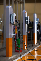 Fototapeta na wymiar EV charging and electric car, Electric car charging station for charge EV battery, Plug for vehicle with electric engine, EV charger clean energy, Charging point at car parking lot.