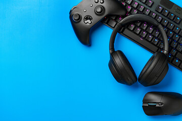 Computer keyboard and joystick on blue background top view © fotofabrika