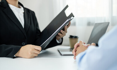 Business people hold a resume and talk to job applicants for job interviews about careers and Their personal history in the company. Recruitment concepts