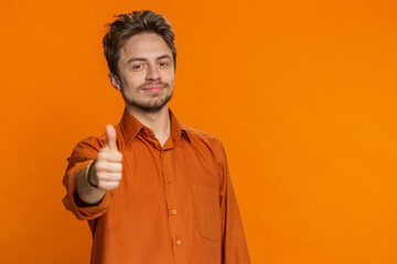 Like. Happy bearded man raises thumbs up agrees with something or gives positive reply recommends...