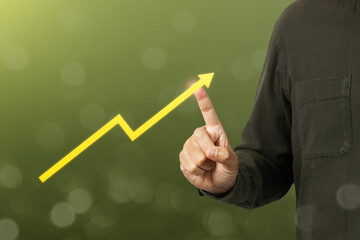 Hand touching arrows pointing up with graph as a symbol of growth and success or rising successful development and business development in the future. Business concept