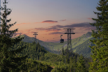 Obraz premium Polish Tatras in Zakopane, the funicular goes up the mountains through the forest, photo at sunset.