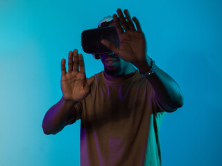 Immersed in a digital realm, an African American man navigates the virtual landscape with a VR...