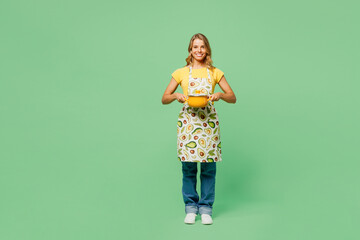 Full body young happy housewife housekeeper chef cook baker woman she wear apron yellow t-shirt...