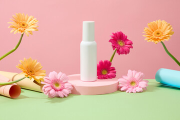 Front view of an unlabeled white cosmetic bottle displayed on a podium. The surrounding is decorated with bright gerbera flowers on a pastel background.