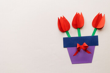 craft for kids on beige background. card with bouquet of paper flowers for mother's day, March 8 or birthday. DIY create art for children