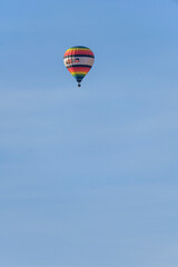 Hot Air Balloon Soaring Over Rugged Canyon Landscape