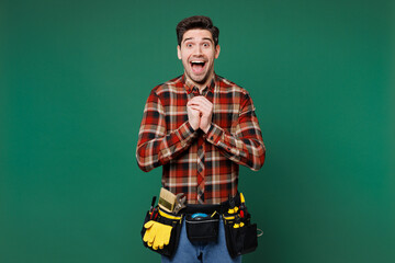 Young shocked surprised amazed employee laborer handyman man wear red shirt look camera isolated on...