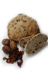 Homemade sliced Pan co' Santi from Tuscany (Italy) isolated on white background. Traditional sweet bread with raisins, almonds, walnuts and aniseed and Vinsanto