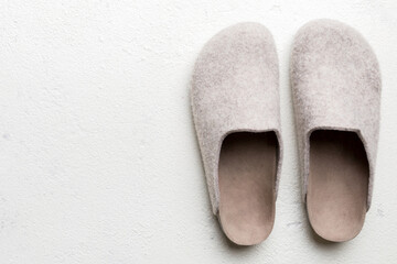Warm winter women woolen slippers on colored background. Copy space for text