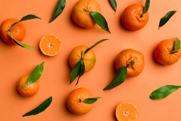 Many fresh ripe mandarin as colored background, top view. Elegant background of clementines and...