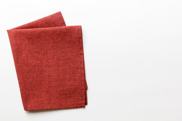 top view with red empty kitchen napkin isolated on table background. Folded cloth for mockup with copy space, Flat lay. Minimal style
