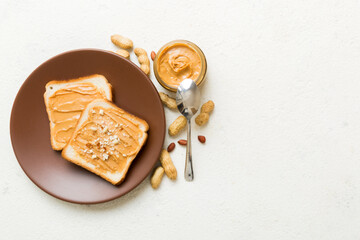 Obraz na płótnie Canvas Peanut butter sandwiches or toasts on light table background.Breakfast. Vegetarian food. American cuisine top view vith copy space