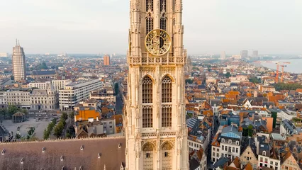 Fototapeten Antwerp, Belgium - July 21, 2023: Spire with the clock of the Cathedral of Our Lady (Antwerp). City Antwerp is located on river Scheldt (Escaut). Summer morning, Aerial View © nikitamaykov