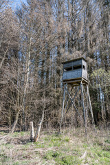A hunters seat in the woods surrounded by trees in winter. Seen in a German forest