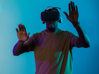 Immersed in a digital realm, an African American man navigates the virtual landscape with a VR...