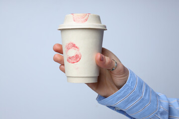 Imprint of a kiss on a paper cup.