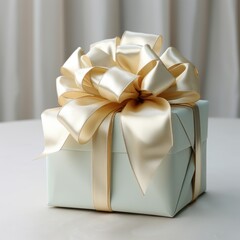 Gift box with gold bow on white table and curtain background.