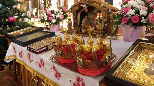 Church crowns, the Gospel and the nativity scene on the throne in the temple. Slow motion