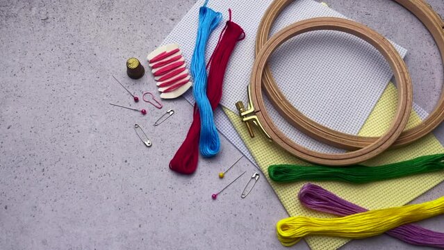 Supplies for hand embroidery.  Hoops with  canvas, scissors,  cotton threads. 