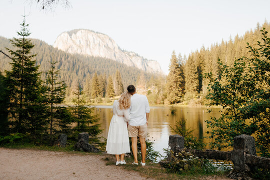 Back view of a couple  looking at beautiful mountains.