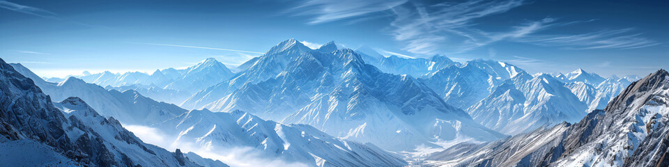 Fototapeta premium Snow-covered mountain range under a clear blue sky. Panoramic nature landscape for winter travel and tourism concept design 