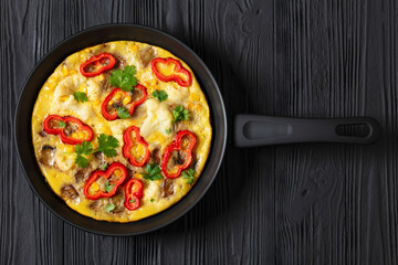 omelette with vegetables in a pan, top view