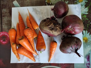 Fresh vegetables carrots and beets on the table, top view