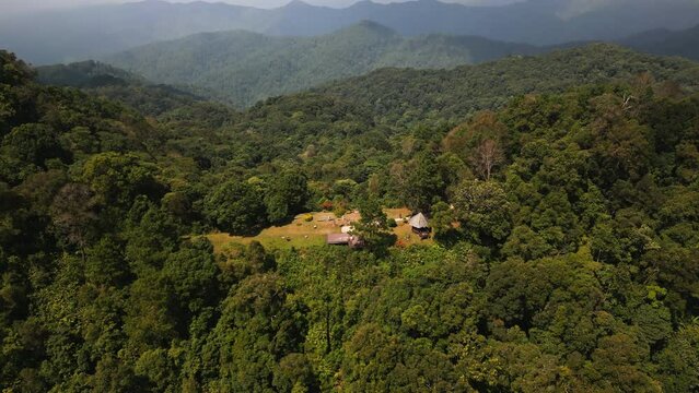 Aerial drone fly near Kew Fin viewpoint, Thailand. View of deep forest, mountains and hills in jungle. Cloudy weather.