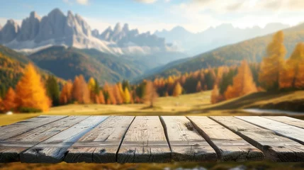 Fototapeten Wooden table top on blurred background of autumn color landscape in dolomites - for display your products © Lubos Chlubny