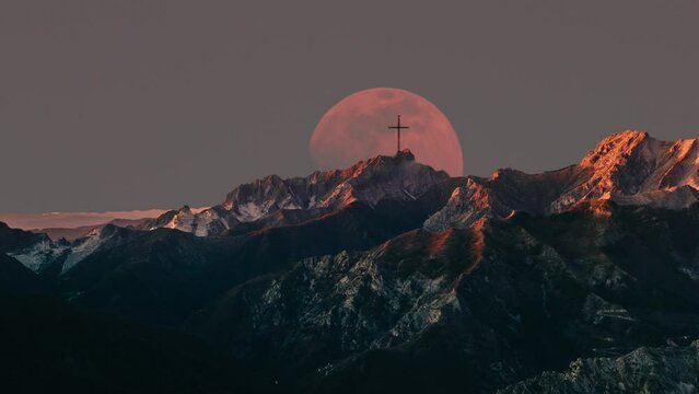 crucifix on mountain top at moonrise