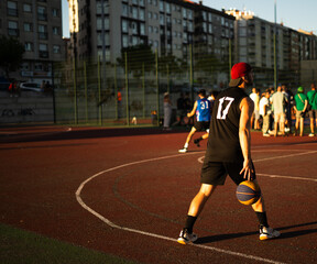 Basketball player training on a court outdoors in summer days- 3x3 red cap
