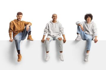 African american guy sitting on a blank panel between caucasian guys - Powered by Adobe