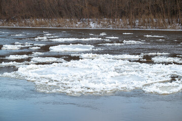 Parts of ice on river. Big river covering in ice floating on the surface