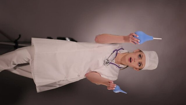 Emotional young woman doctor nurse in a white coat and hat