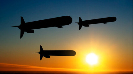 Silhouettes of Tomahawk cruise missiles against the sunset. EPS10 vector