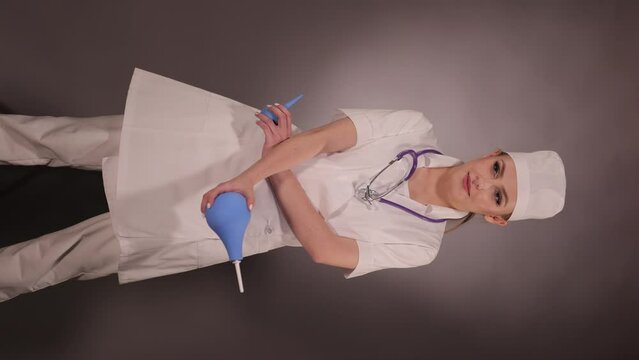 Emotional young woman doctor nurse in a white coat and hat