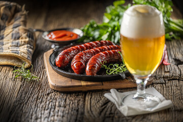 Sausages fried with spices bbq sauce draft beer and herbs - Close up