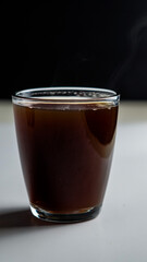 a cup of hot coffee in a clear glass