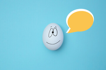 Smiling egg with social chat sign and speech bubbles. Copy space. Like at social network, emoticons...