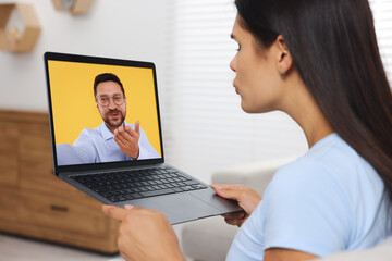 Long distance love. Woman having video chat with her boyfriend via laptop at home - obrazy, fototapety, plakaty