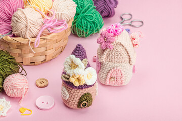 Fototapeta na wymiar Handmade spring decor concept. Creative crocheting, house figurines, traditional flowers and stuff