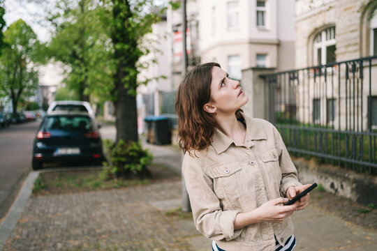 Young Person Searching for Directions in the City with Smartphone in Hand