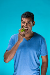 Happy Indian man holding an apple.