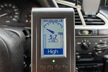 Measuring the magnetic field in a car using an electromagnetic field measuring tool, EMF meter
