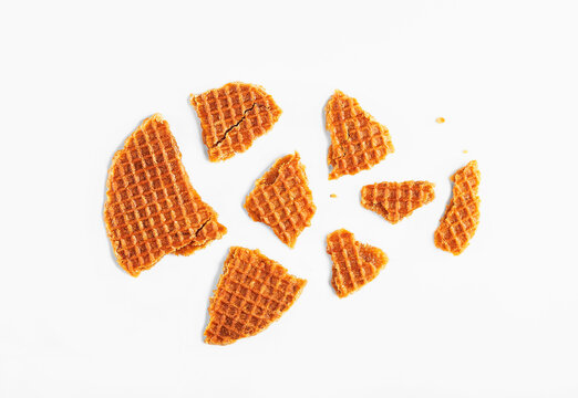 Stroopwafel broken on white background. Dutch waffle caramel cookie. Delicious snack concept. Selective focus