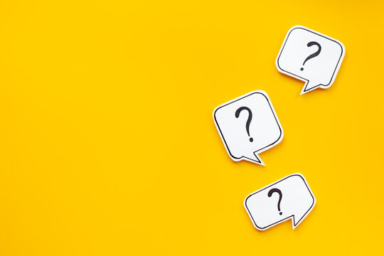 Ask and answer concept. Question marks on speech bubbles, top view